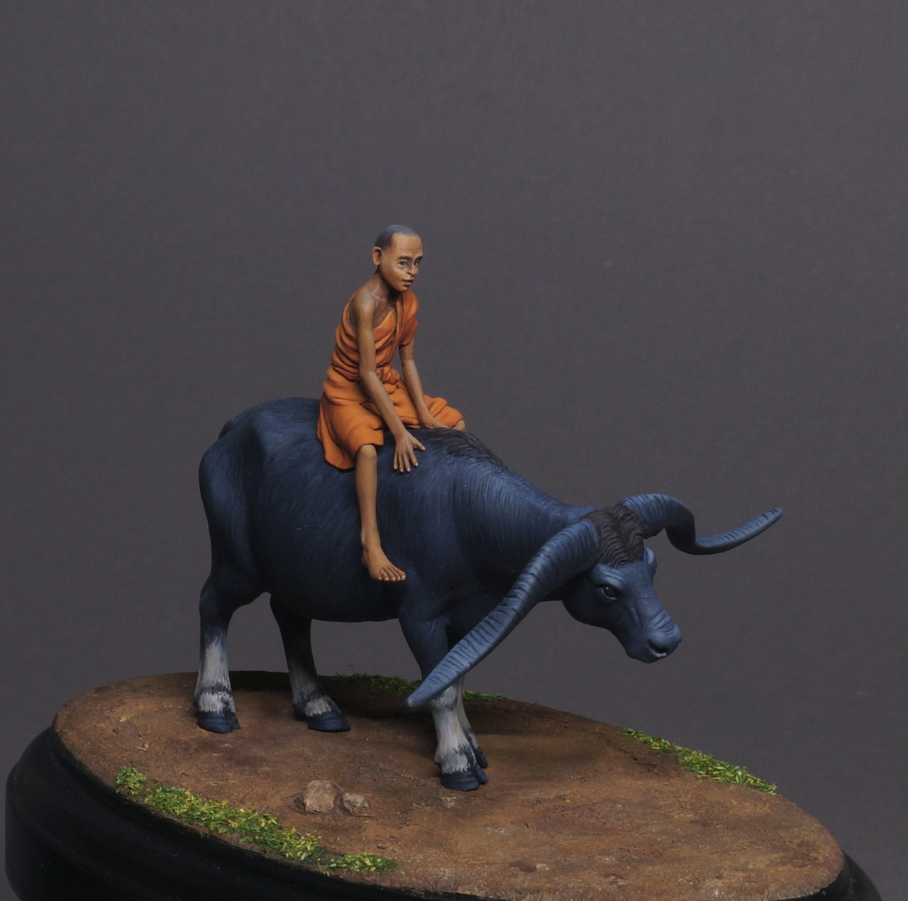 Figures: Boy on buffalo, photo #1